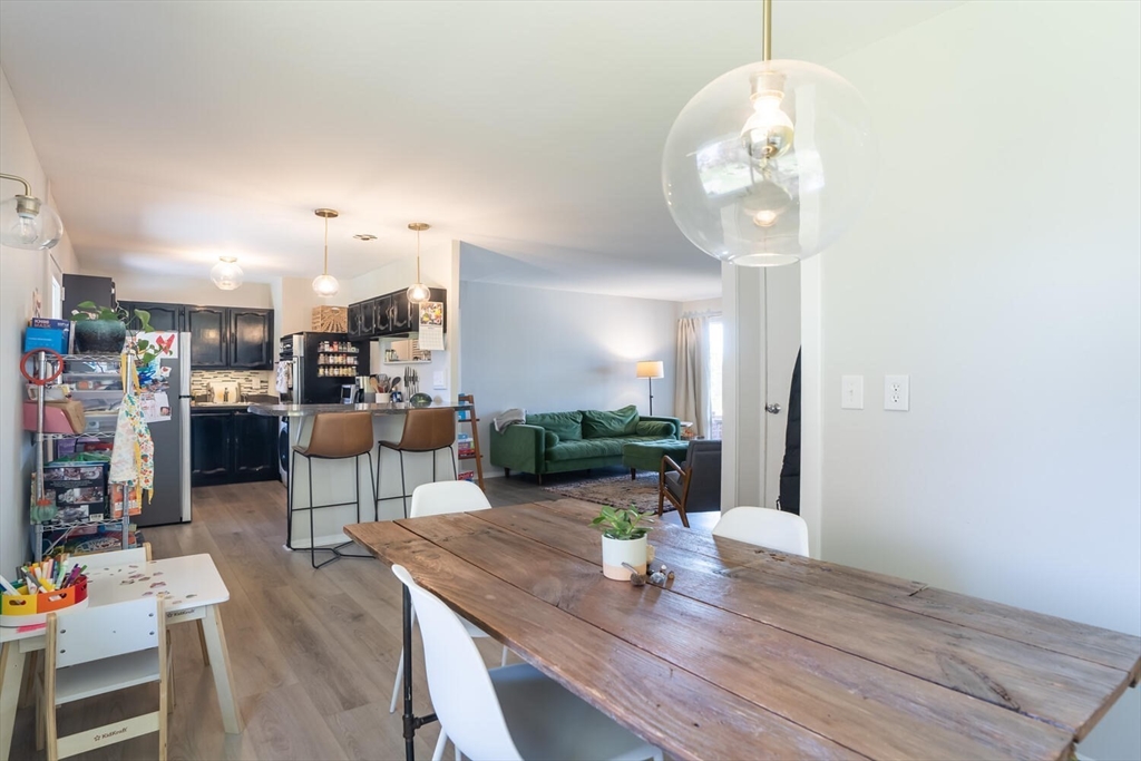 392 Bridge Street Northampton, MA 01060 - Photo 9 of 36 an open kitchen with dining table and chairs