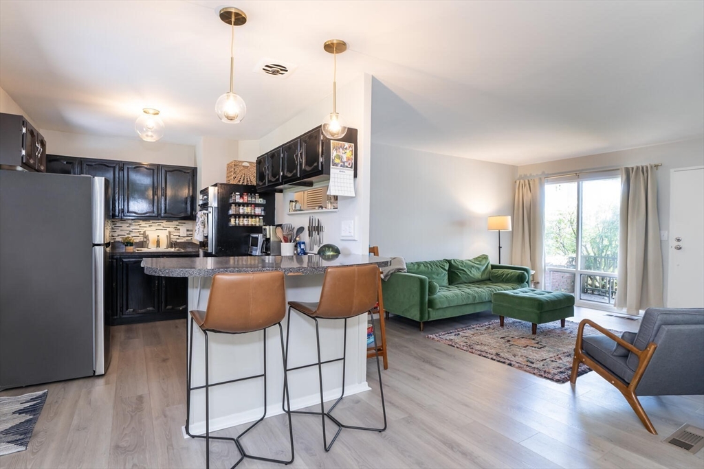 392 Bridge Street Northampton, MA 01060 - Photo 10 of 36 a kitchen with kitchen island stainless steel appliances microwave stove dining table and chairs