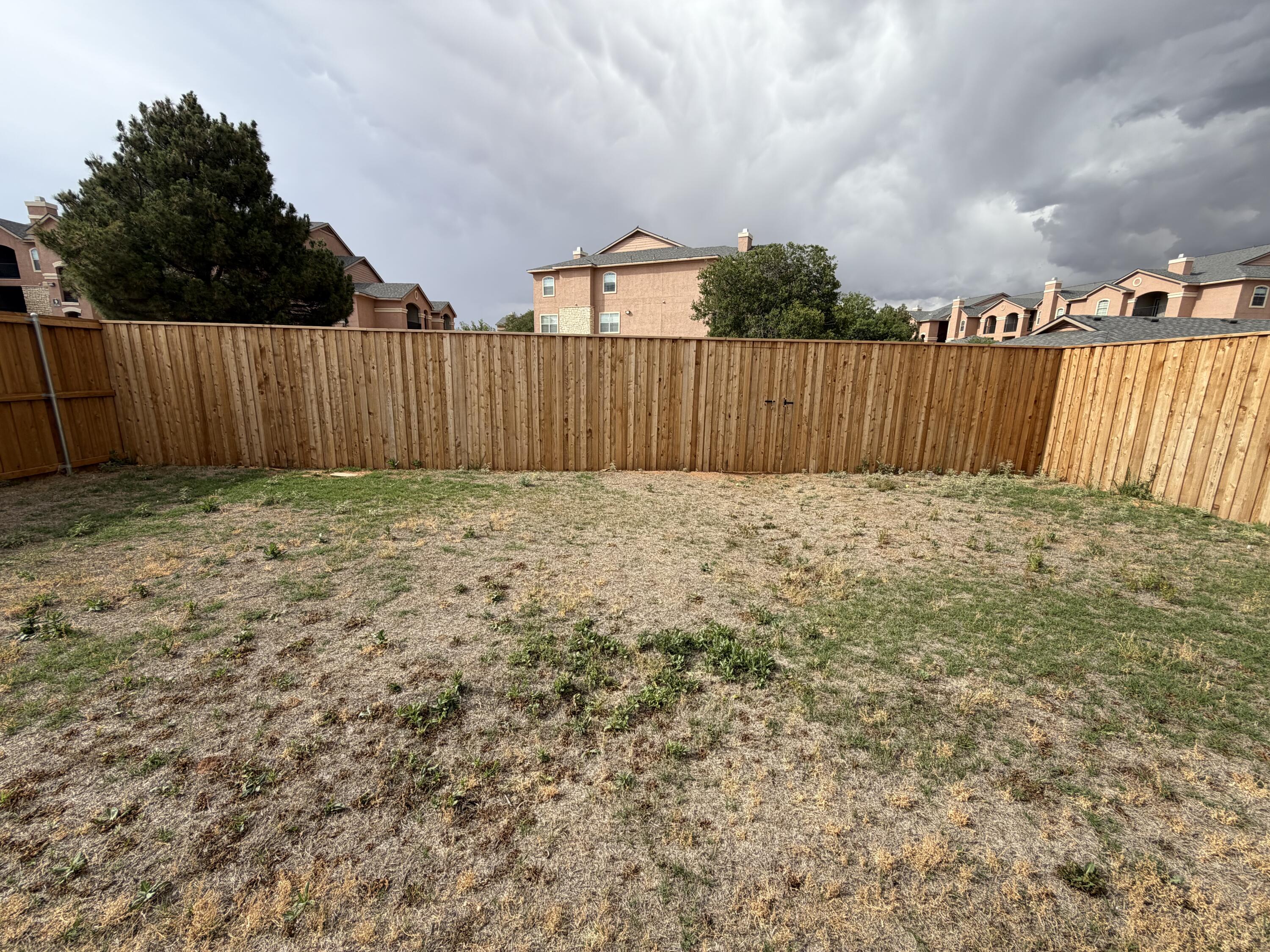 6544 84th Street Lubbock, TX 79424 - Photo 5 of 29 a view of backyard with wooden fence