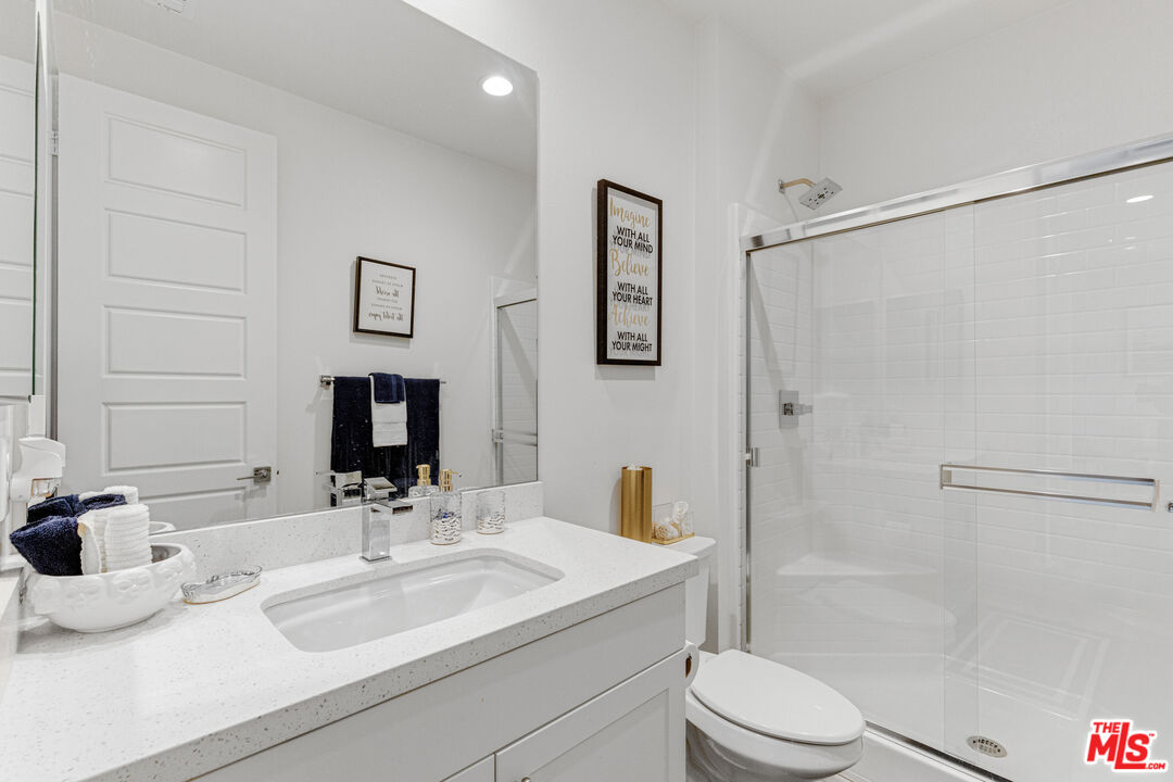 24477 Oneida Street Moreno Valley, CA 92553 - Photo 14 of 51 a bathroom with a sink toilet and shower