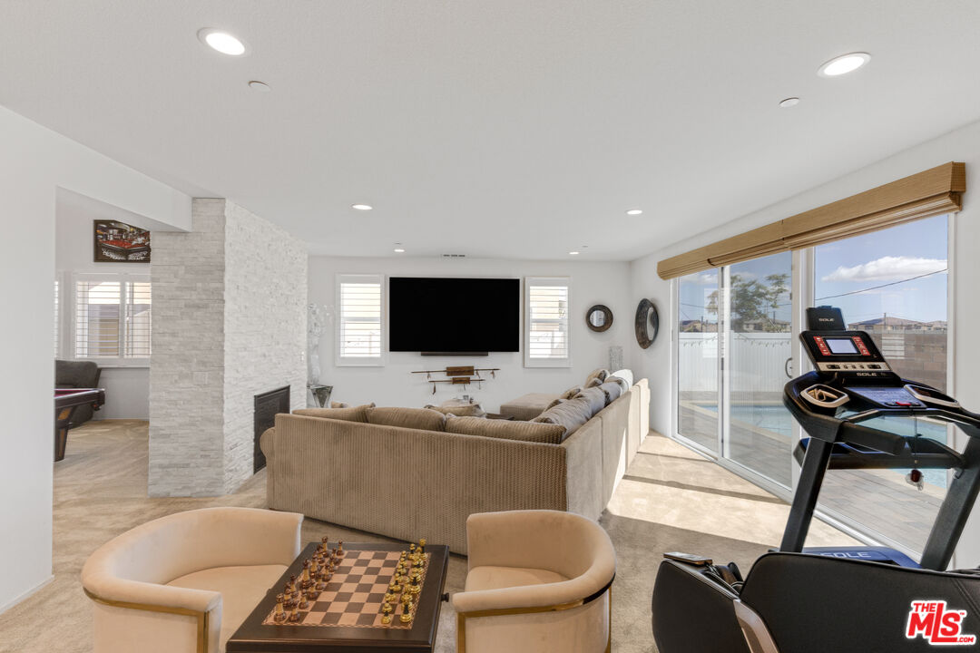 24477 Oneida Street Moreno Valley, CA 92553 - Photo 15 of 51 a living room with furniture a flat screen tv and a large window