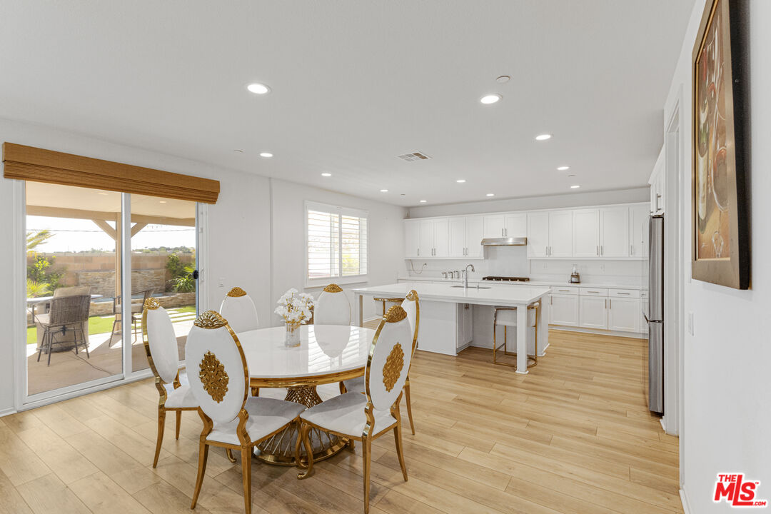 24477 Oneida Street Moreno Valley, CA 92553 - Photo 16 of 51 a view of a dining room with furniture and wooden floor