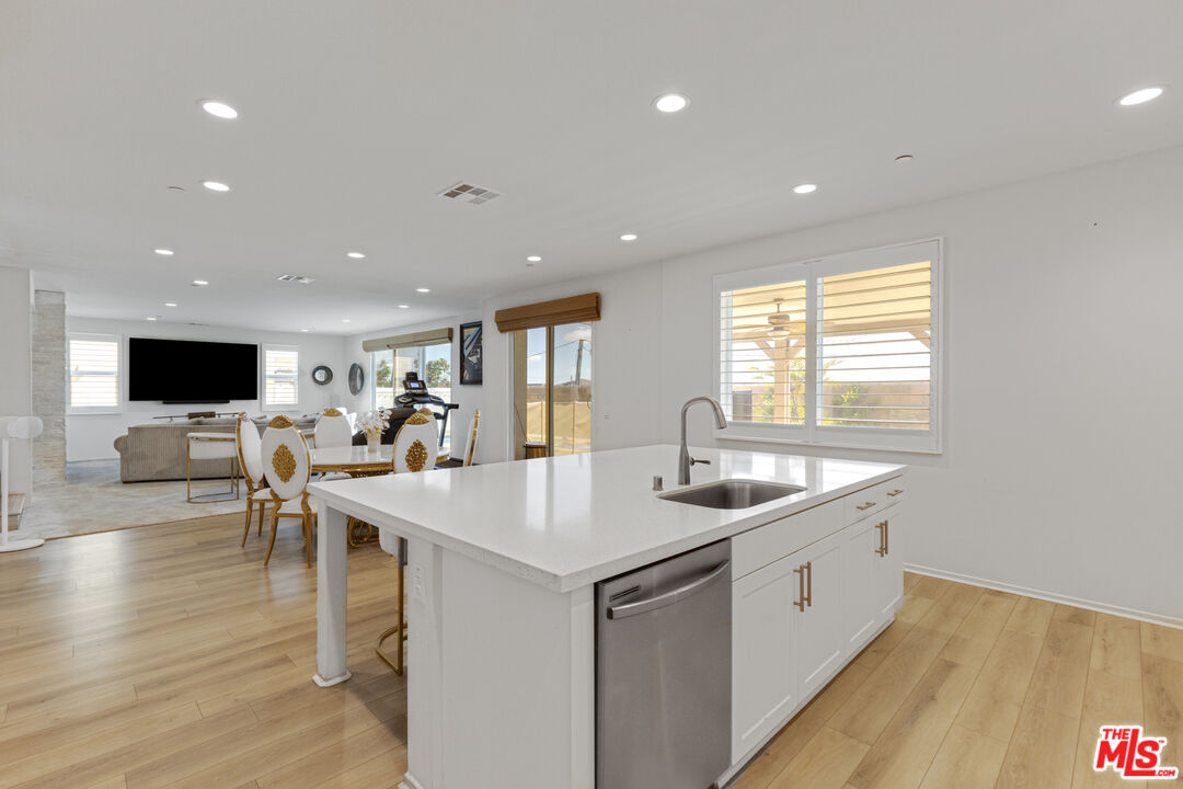 24477 Oneida Street Moreno Valley, CA 92553 - Photo 19 of 51 a kitchen with a sink and chairs