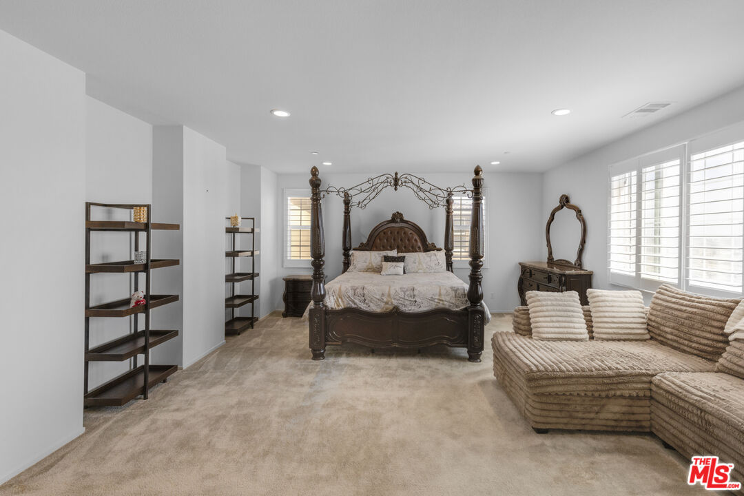 24477 Oneida Street Moreno Valley, CA 92553 - Photo 24 of 51 a bedroom with a bed a couch and a large window