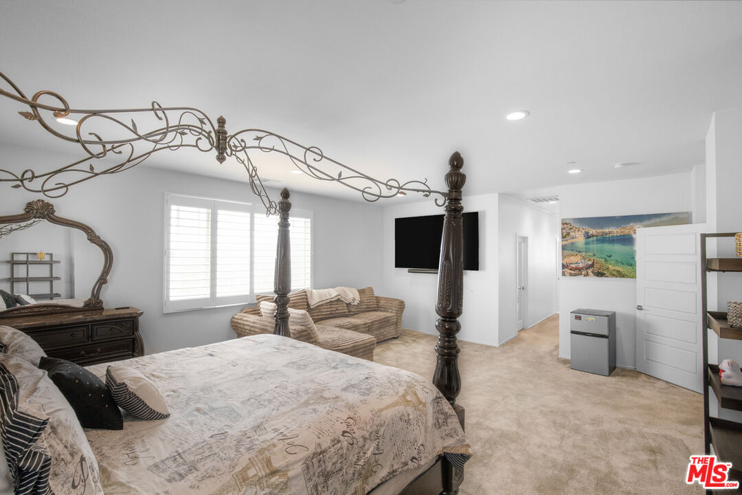 24477 Oneida Street Moreno Valley, CA 92553 - Photo 25 of 51 a bedroom with furniture and a flat screen tv