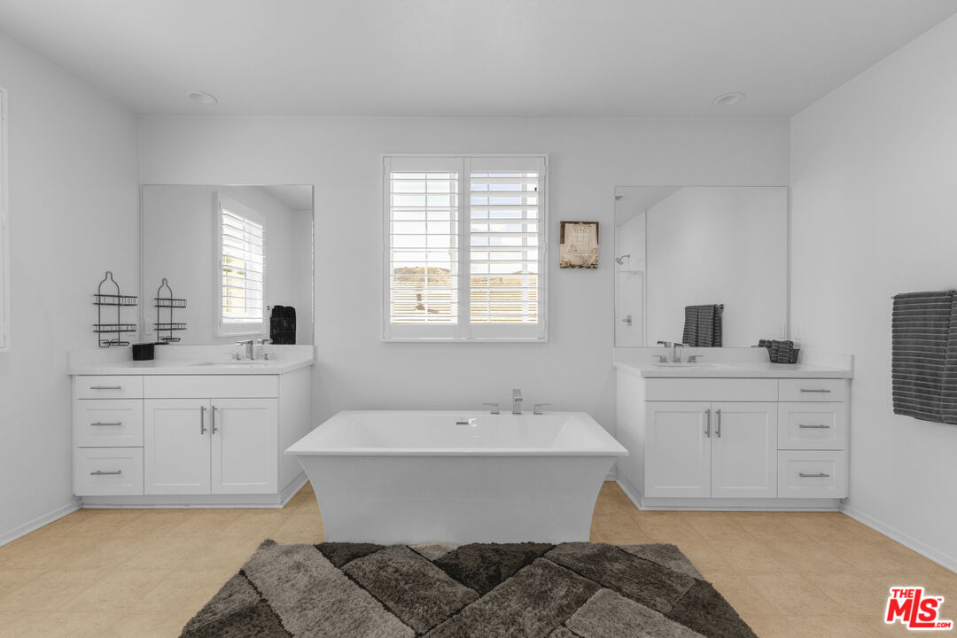 24477 Oneida Street Moreno Valley, CA 92553 - Photo 26 of 51 a spacious bathroom with sinks mirror and vanity