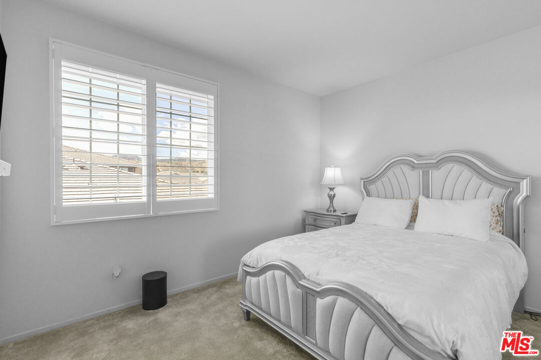 24477 Oneida Street Moreno Valley, CA 92553 - Photo 33 of 51 a bedroom with a bed and a window