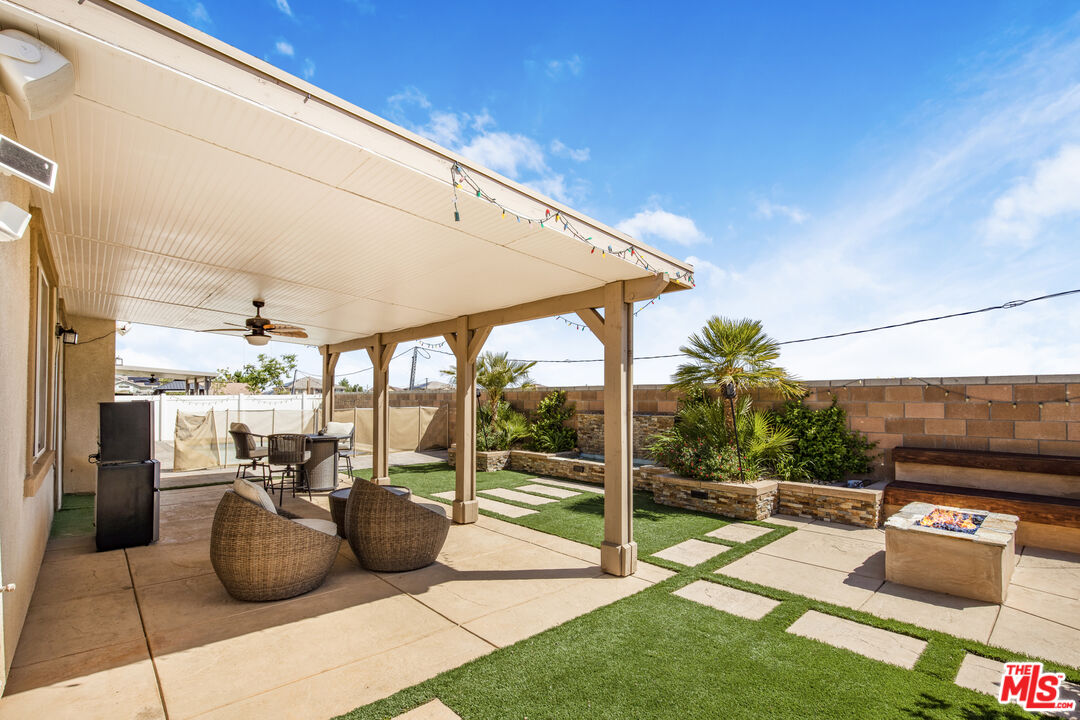 24477 Oneida Street Moreno Valley, CA 92553 - Photo 38 of 51 a view of a patio with couches and table and chairs and potted plants