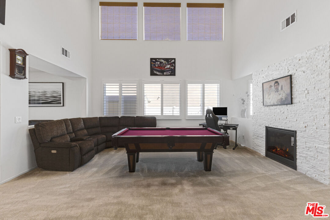 24477 Oneida Street Moreno Valley, CA 92553 - Photo 9 of 51 a living room with furniture a flat screen tv and a fireplace