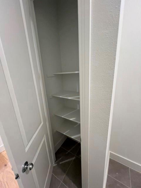 1407 Cartona Road Fate, TX 75087 - Photo 15 of 21 Storage closet featuring multiple white shelving units and tile flooring