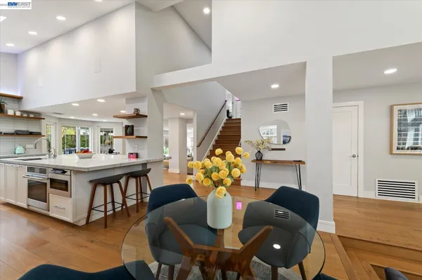 a large kitchen with kitchen island a sink table and chairs