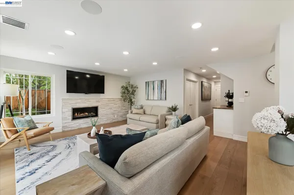 a spacious bedroom with a bed and a flat screen television