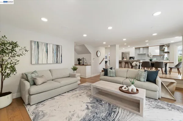 a spacious bedroom with a bed and a chandelier