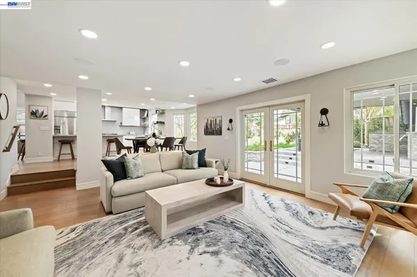 a en suite bathroom with a double vanity sink a mirror and a bathtub
