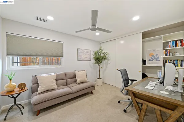a view of a swimming pool and lounge chairs