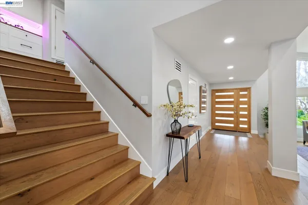 a living room with furniture wooden floor and a fireplace