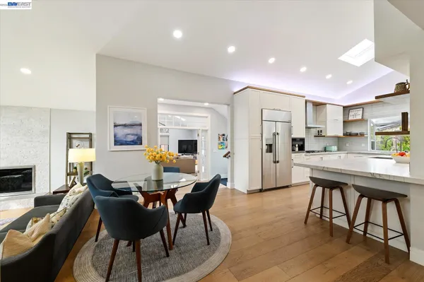 a living room with furniture potted plant and a large window