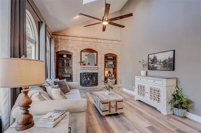 a living room with furniture a fireplace and a flat screen tv