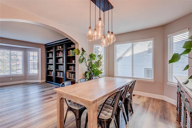 a view of a dining room with furniture wooden floor and chandelier