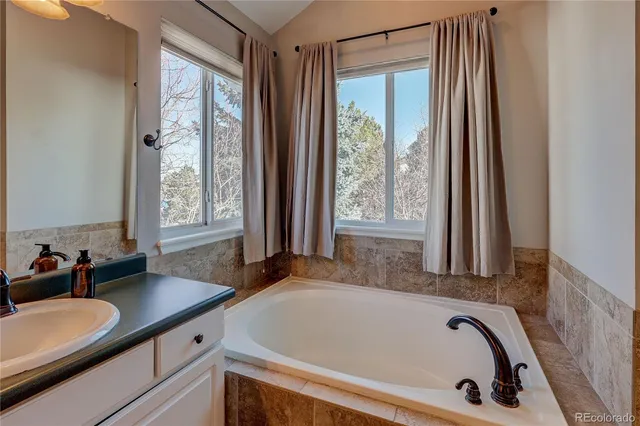 a bath tub sitting in a bathroom next to a window