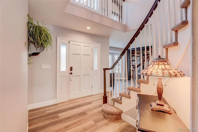 a view of entryway and hall with wooden floor