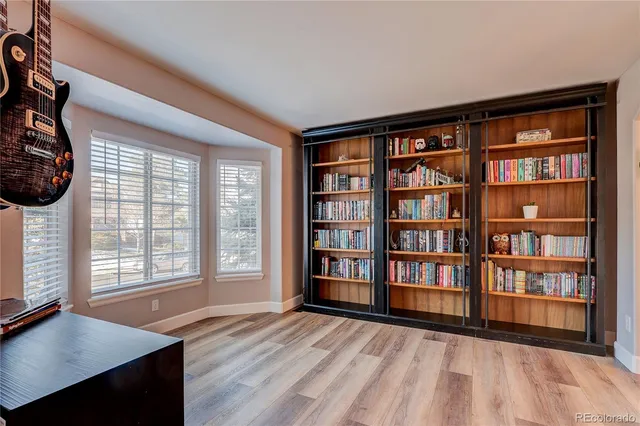 a view of an empty room with furniture and a window