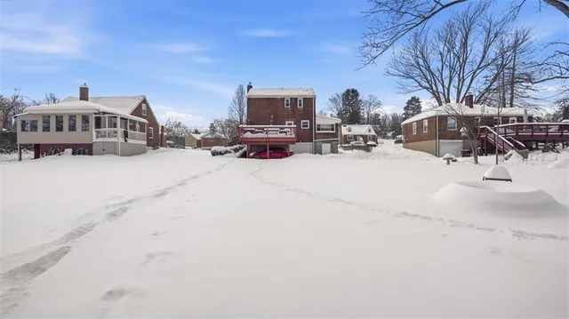 a view of a house with a snow in the background