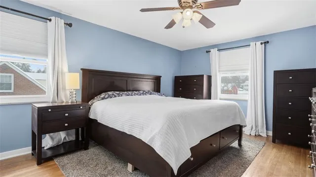 a bedroom with a large bed and a window