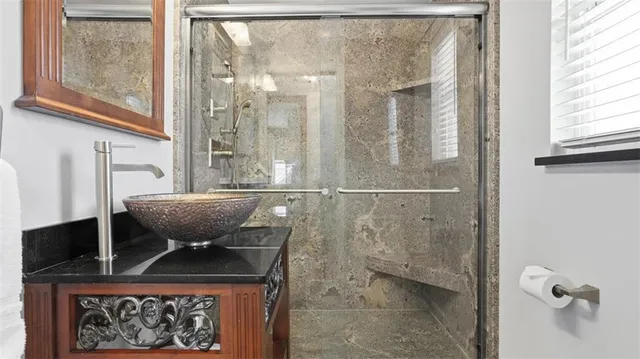 a view of bathroom with a shower and a sink