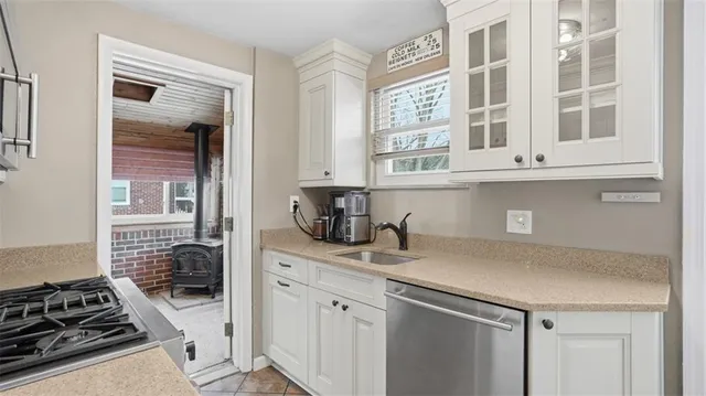 a kitchen with stainless steel appliances granite countertop a stove and a sink