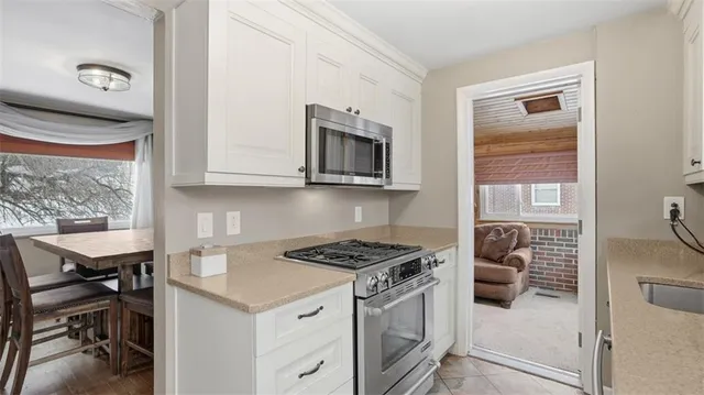 a kitchen with stainless steel appliances a stove a microwave and a refrigerator