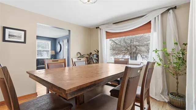 a view of a dining room with furniture and a window