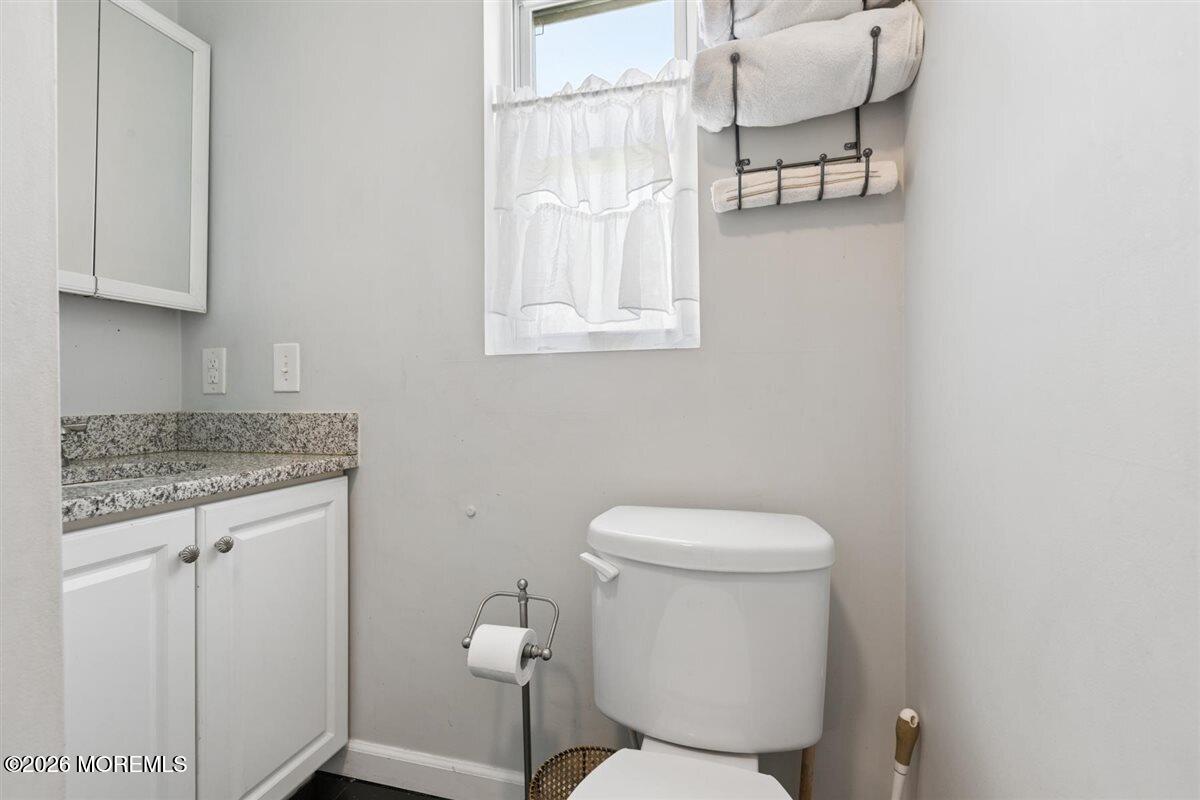 436 Cook Road Jackson, NJ 08527 - Photo 18 of 44 a white toilet sitting next to a bathroom sink