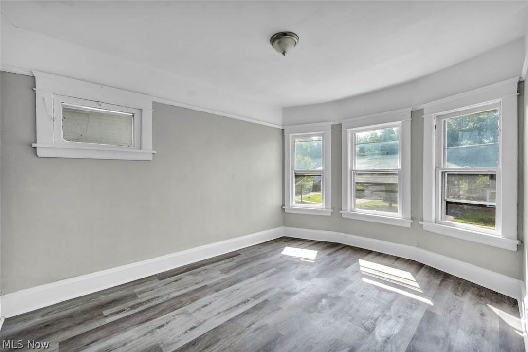1659 Lee Road Cleveland, OH 44118 - Photo 19 of 46 Wood-finish flooring, multiple windows, ceiling-mounted light fixture, and light-toned walls