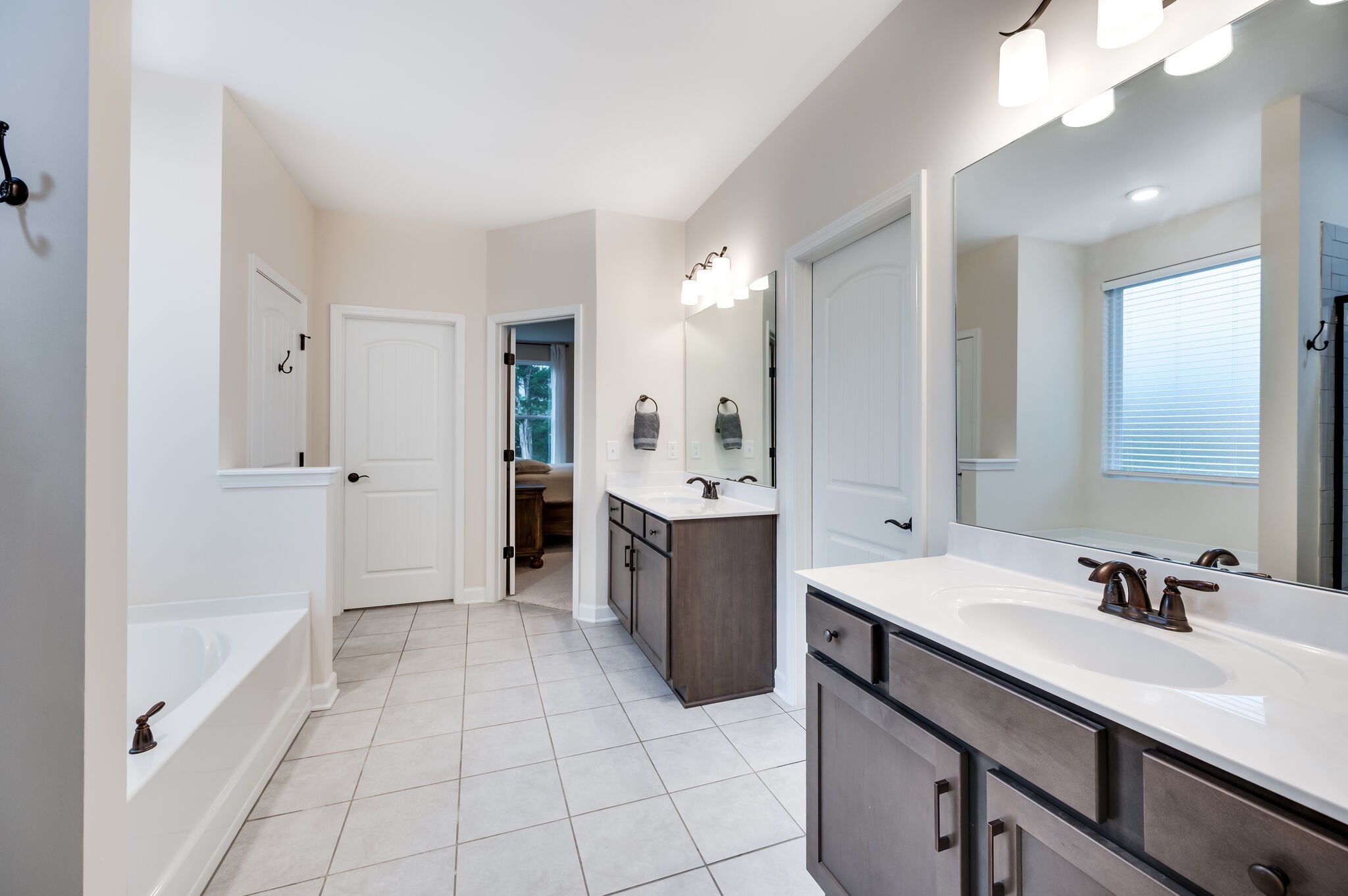 12 Kelly Court Lebanon, TN 37087 - Photo 34 of 55 a spacious bathroom with a double vanity sink a mirror and a bathtub