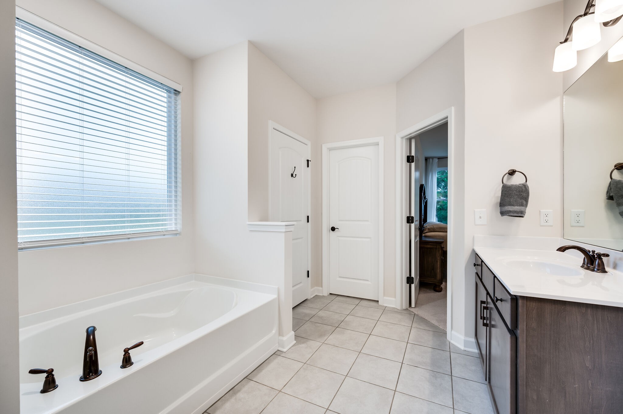 12 Kelly Court Lebanon, TN 37087 - Photo 36 of 55 a bathroom with a tub sink and a mirror