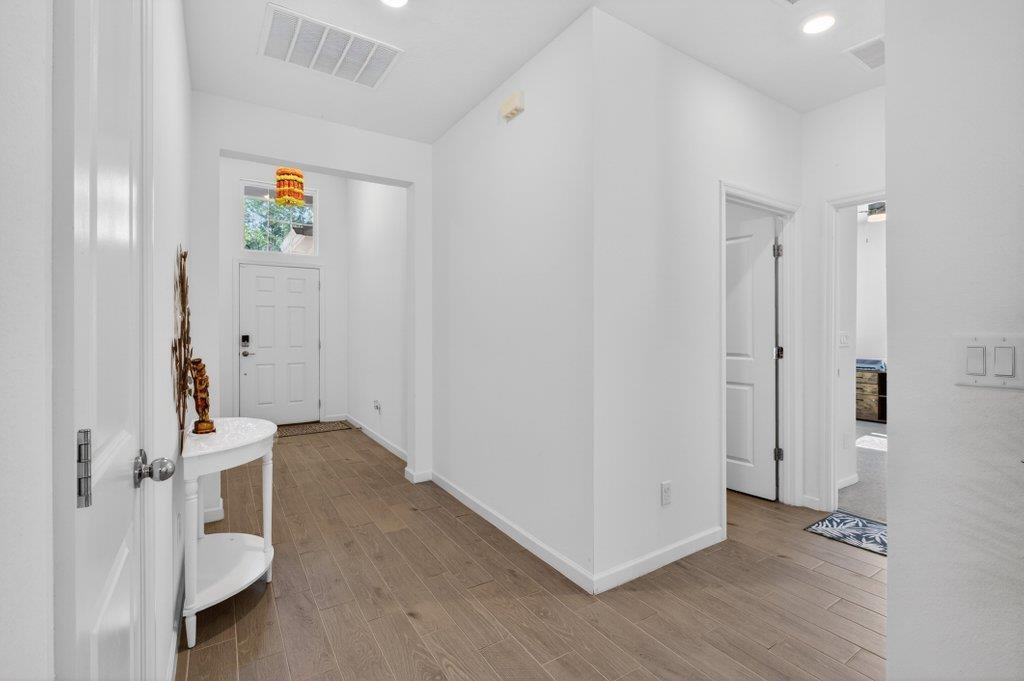 210 White Rabbit Run St. Augustine, FL 32092 - Photo 5 of 85 a view of a hallway with wooden floor and closet area