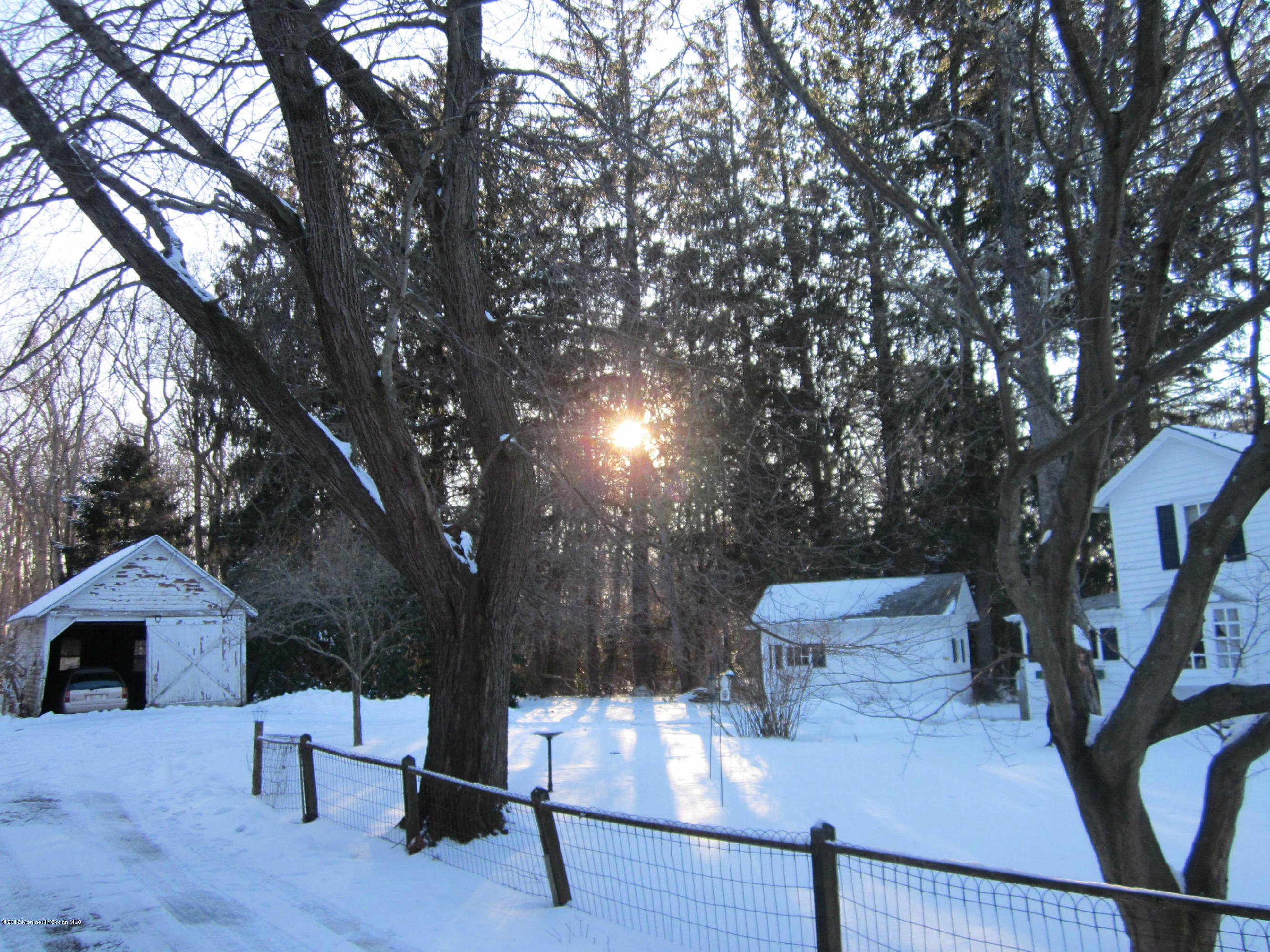 480 Brickyard Road Freehold, NJ 07728 - Photo 6 of 6 a roof deck with table and chairs and a large tree