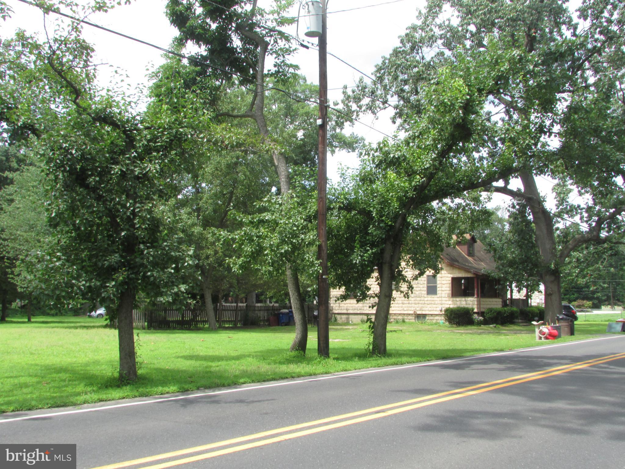 1215 Bridgeboro Road Edgewater Park, NJ 08010 - Photo 5 of 13 a view of a house with a big yard and large trees