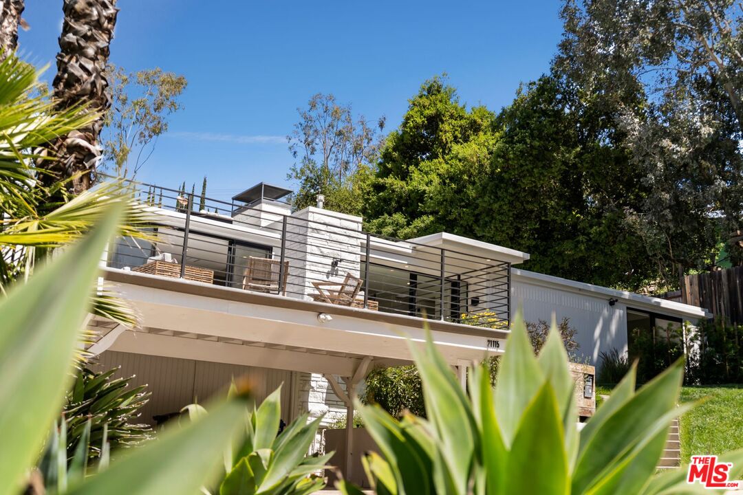 a view of a house with a yard from a balcony