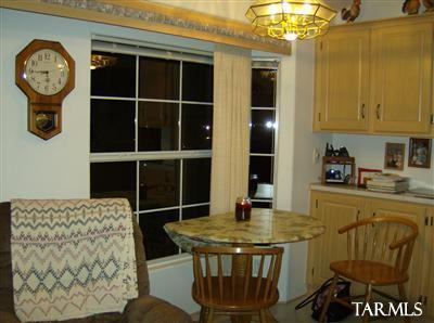74 Cardinal Corner Benson, AZ 85602 - Photo 12 of 21 a view of a dining room with furniture and a chandelier