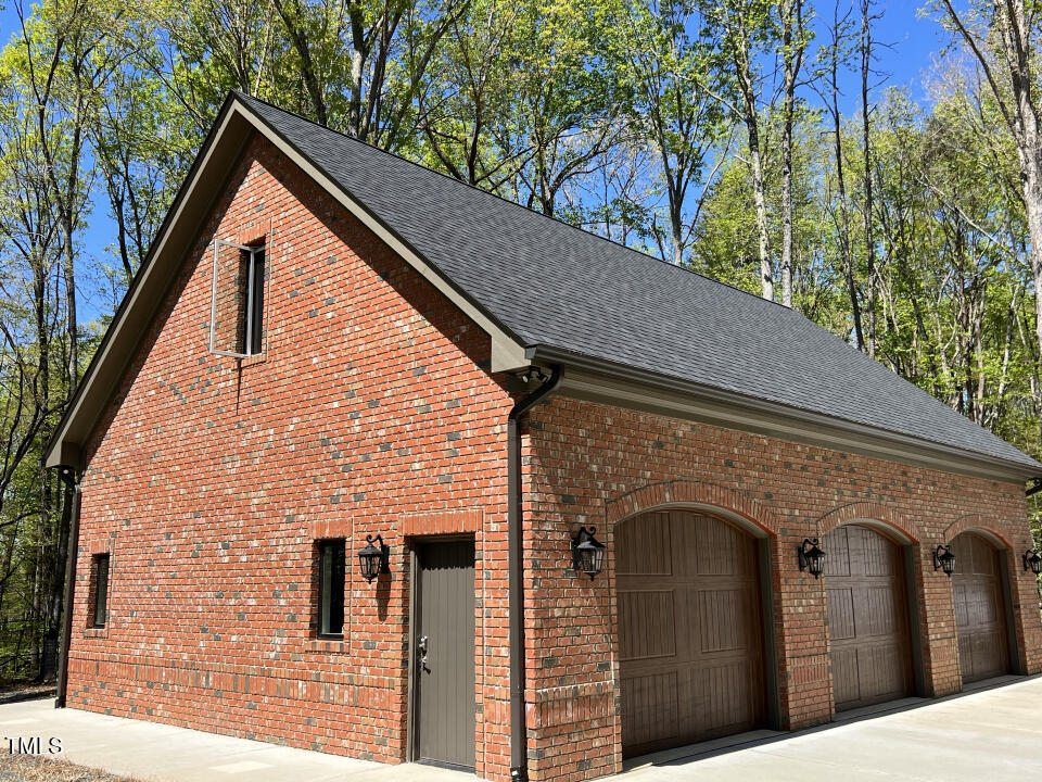 804 Crabtree Glenn Road Rougemont, NC 27572 - Photo 58 of 66 a front view of a house with garage