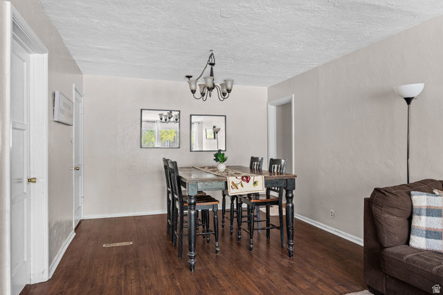 88 East C Street Springville, UT 84663 - Photo 6 of 32 Dining area with wood-finish flooring, light neutral wall paint, and a traditional chandelier