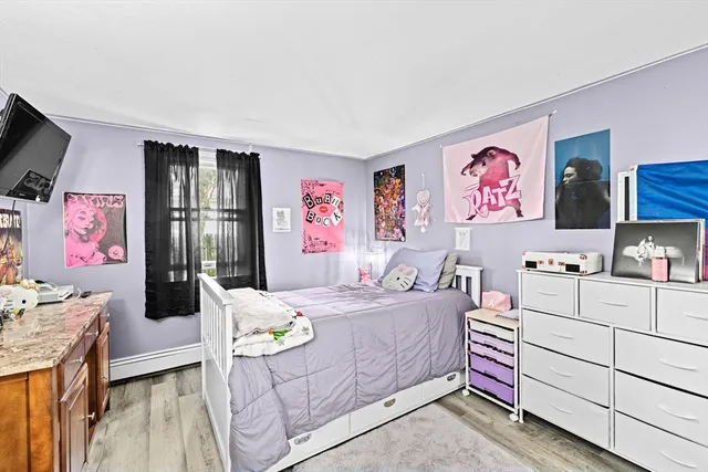 a bedroom with furniture and a flat screen tv