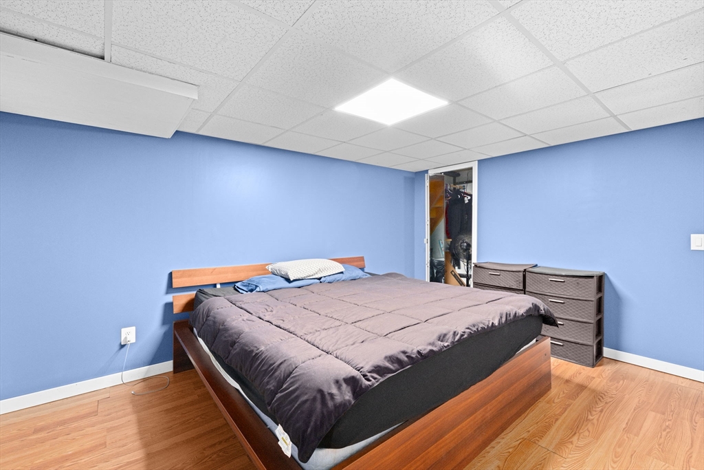 40 Cohasset Road Wareham, MA 02532 - Photo 18 of 42 a bed sitting in a room next to a lamp