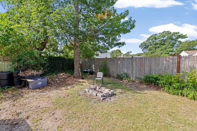 a backyard of a house with table and chairs