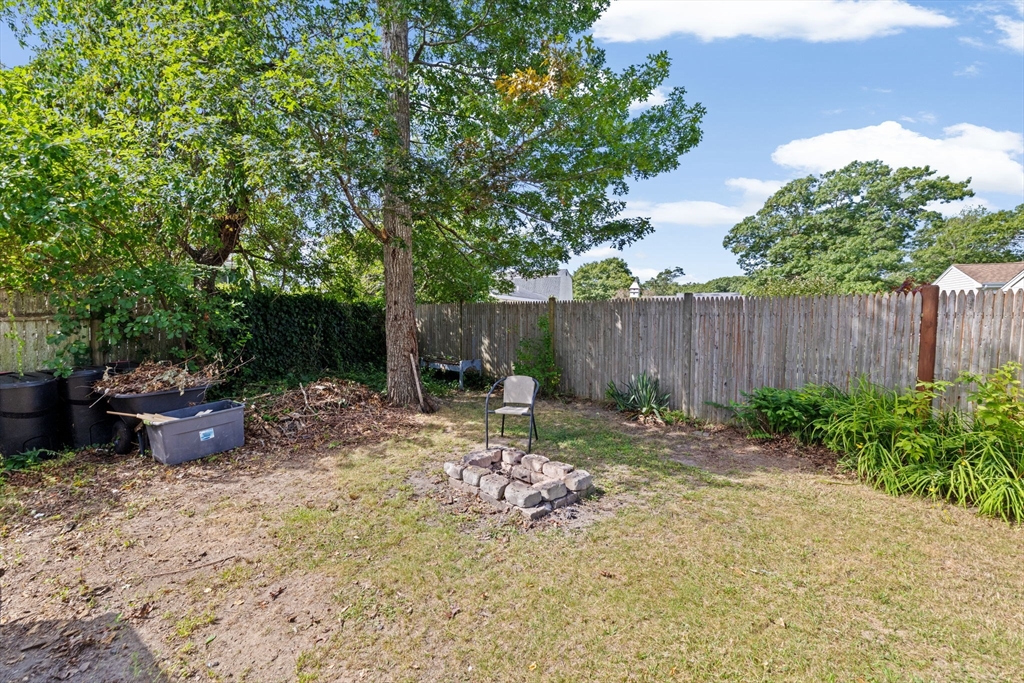 40 Cohasset Road Wareham, MA 02532 - Photo 22 of 42 a backyard of a house with table and chairs