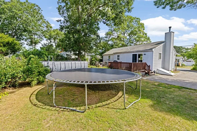 a view of a house with backyard porch and sitting area