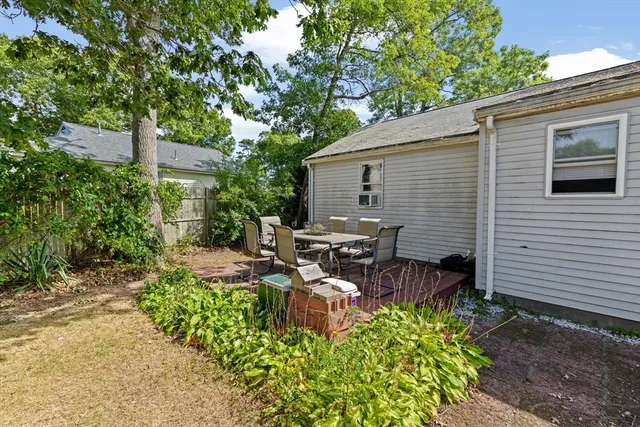 a view of a patio with chairs and potted plants