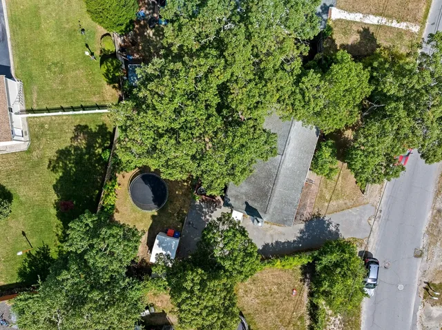 an aerial view of a house with yard swimming pool and outdoor seating